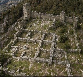 Vue aérienne de la cour intérieure du Castello di Bominaco, tracé des anciennes salles visible au sol.
