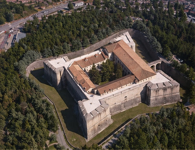 Vue aérienne du Forte Spagnolo de L'Aquila, forteresse carrée aux bastions en pointe de flèche entourée de forêt.
